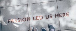Picture of feet on a sidewalk with the words passion led us here